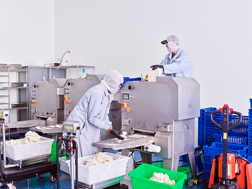 Workers process the My Bacon product 