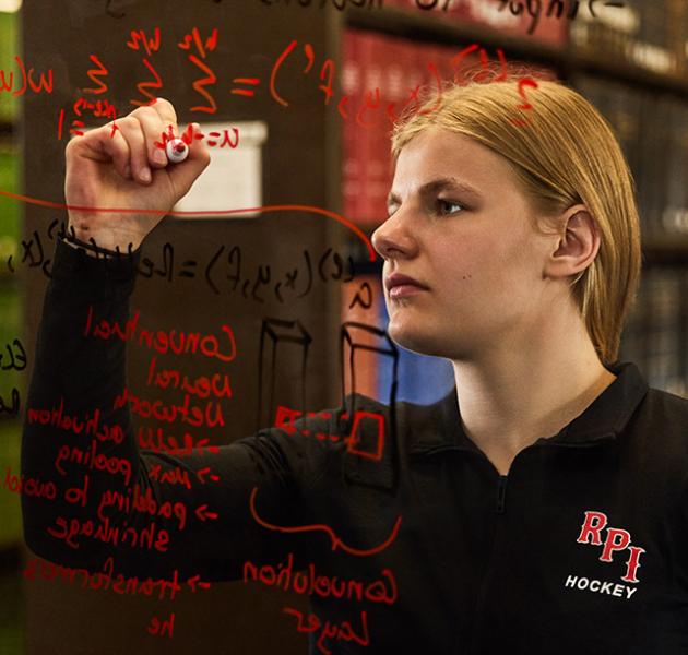Nina writing formulas on glass